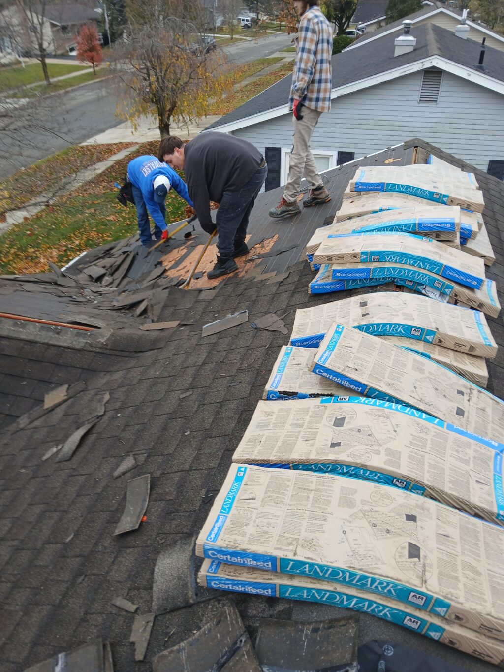 Certified roofer installing Owens Corning shingles with proper underlayment and flashing on a residential roof.