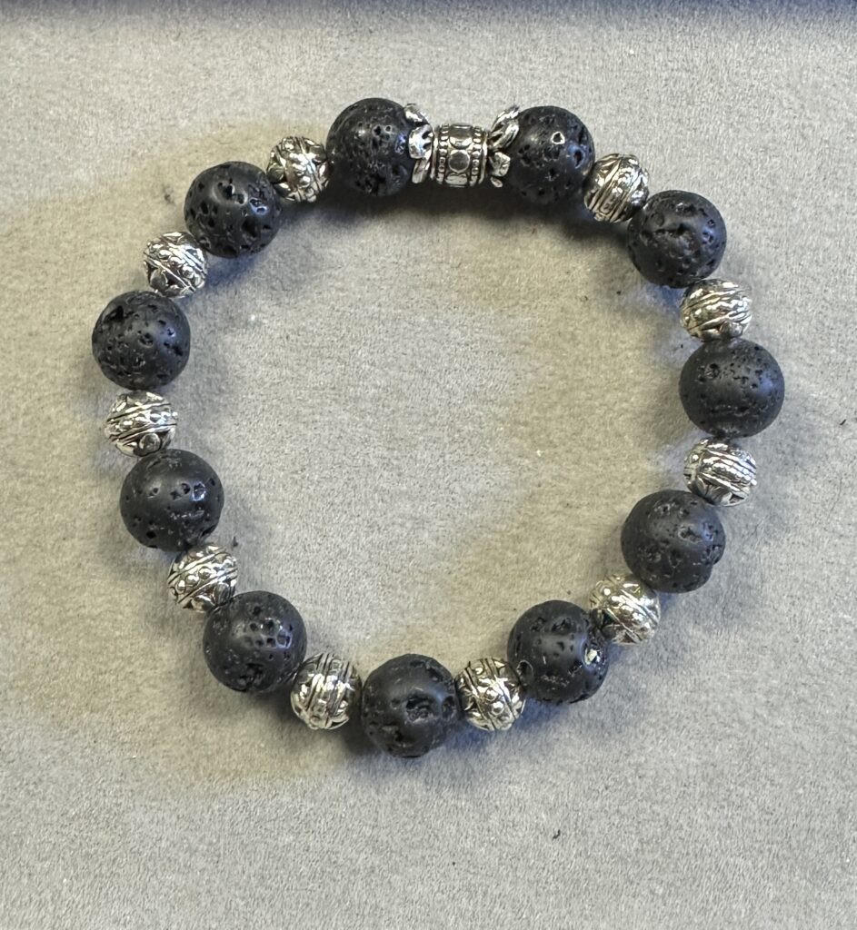 Black lava stone beads with porous volcanic texture used in handmade bracelet jewelry