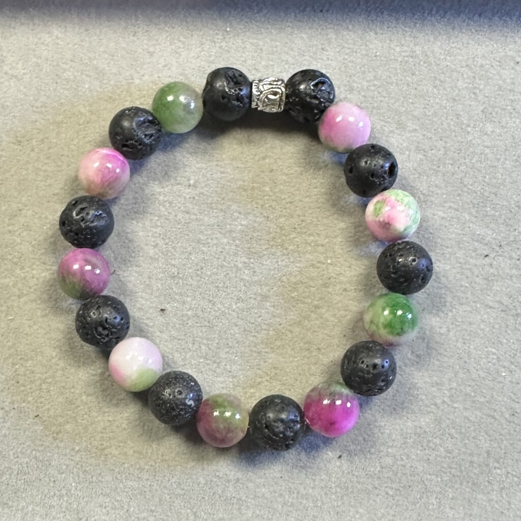 Handmade pink Persian jade and black lava stone bracelet featuring polished and matte natural gemstone beads